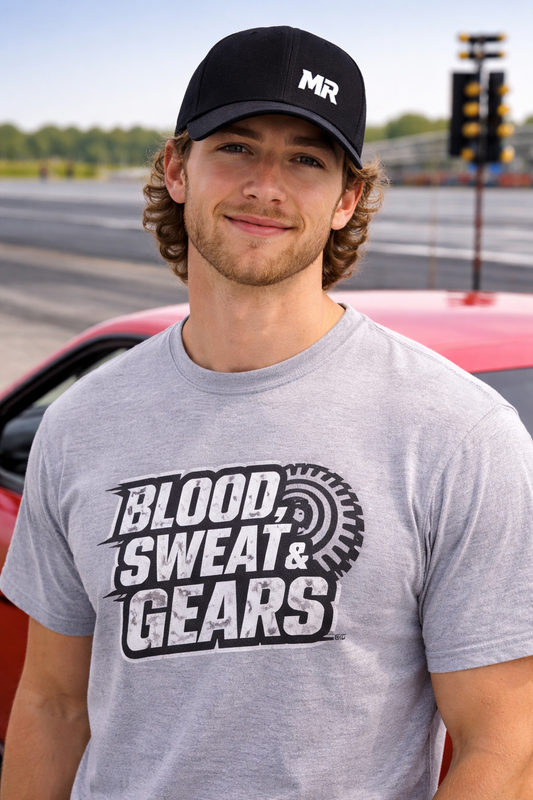 Man wearing a cap and 'Blood Sweat & Gears' t-shirt on a track background