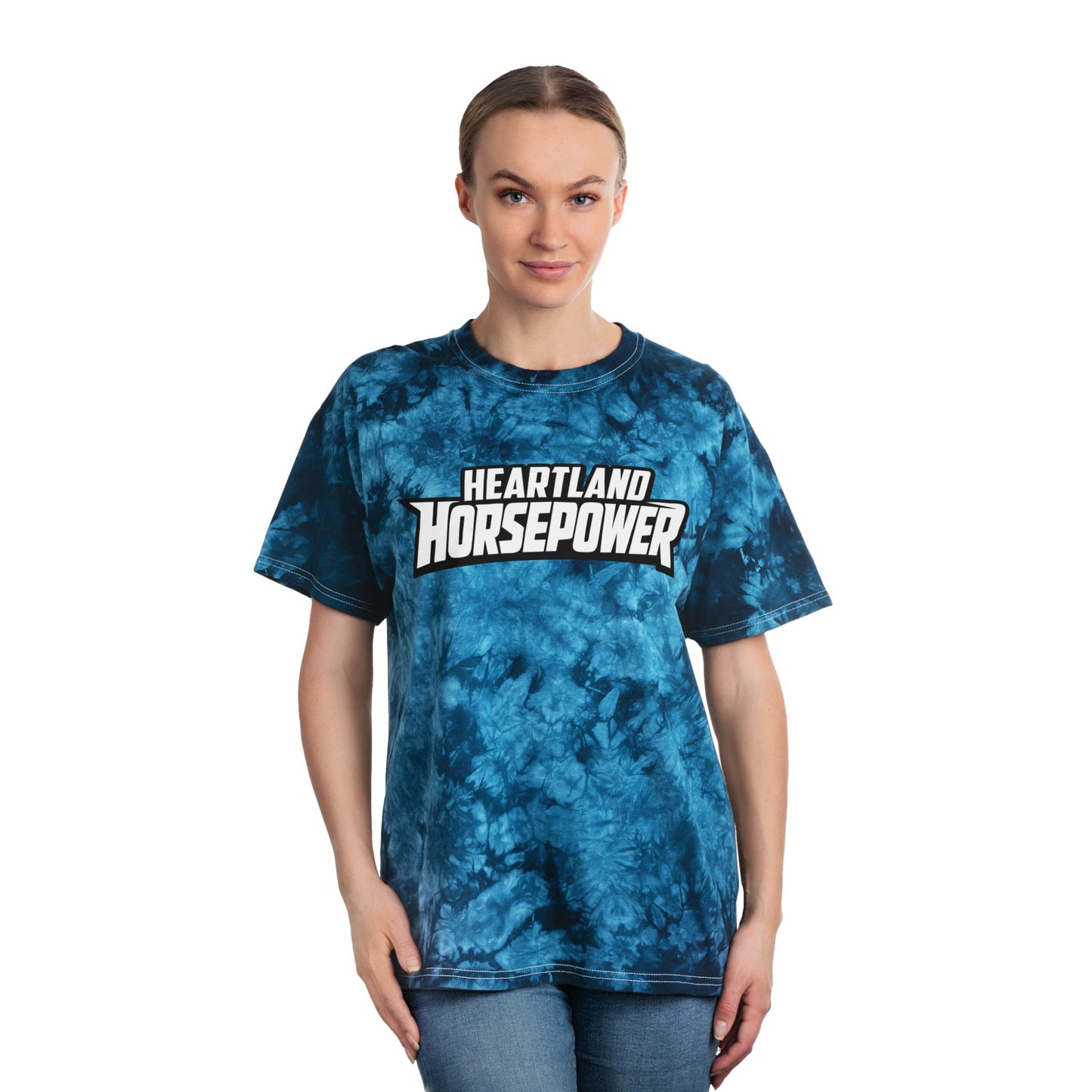 Woman wearing a blue tie-dye t-shirt with 'Heartland Horsepower' text on a white background