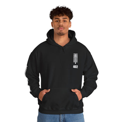 Person wearing a black hoodie with a logo and text on a white background