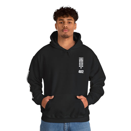 Person wearing a black hoodie with a logo and text on a white background