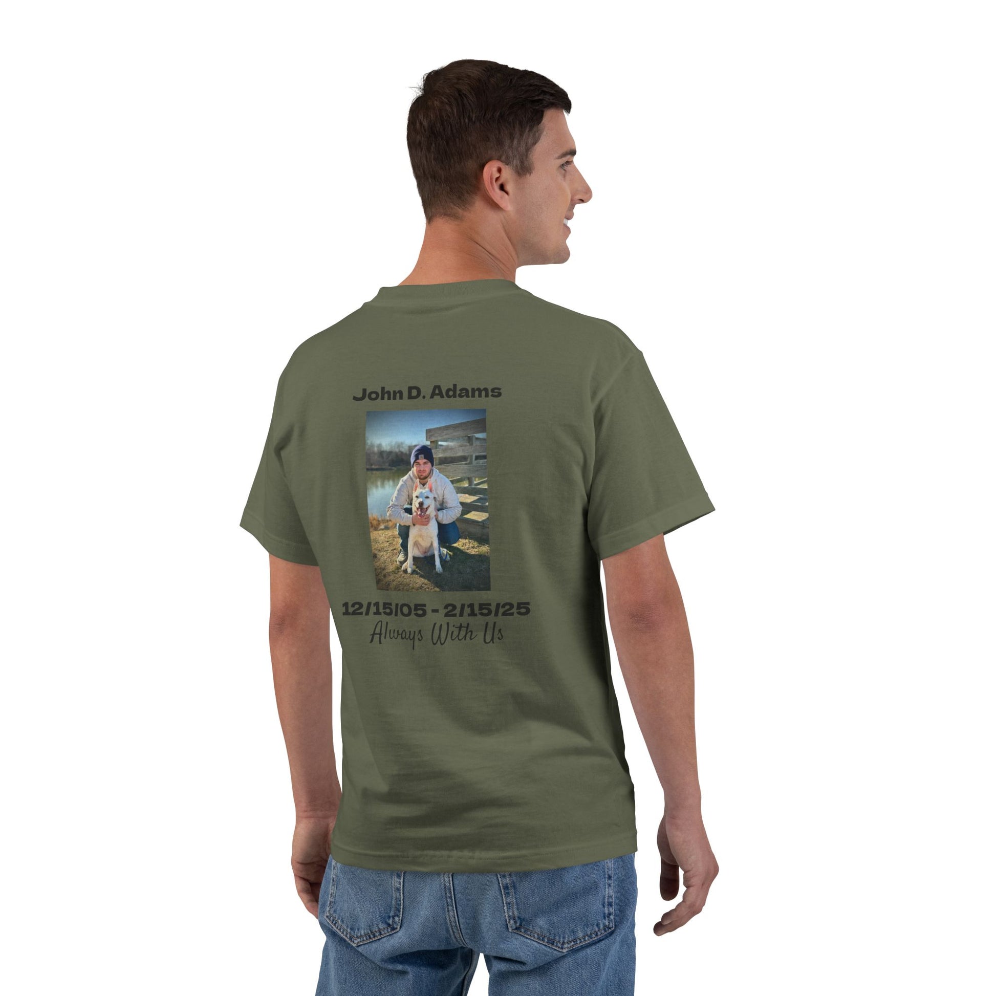 Man wearing a green t-shirt with a photo and text on the back, standing against a white background