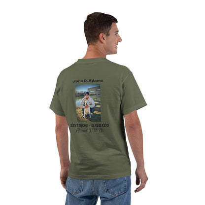 Man wearing a green t-shirt with a photo and text on the back, standing against a white background