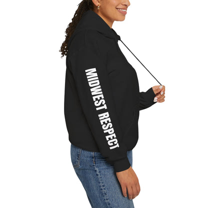Woman wearing a black hoodie with a Midwest Respect design in white on a white background