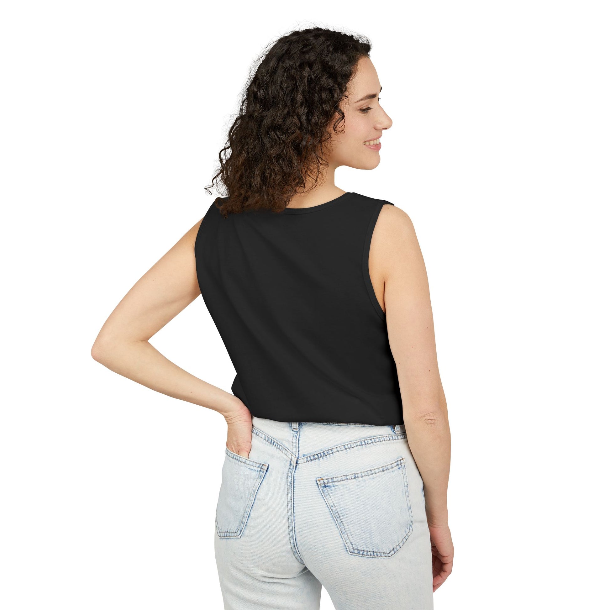 Woman wearing a black sleeveless top and light blue jeans on a white background