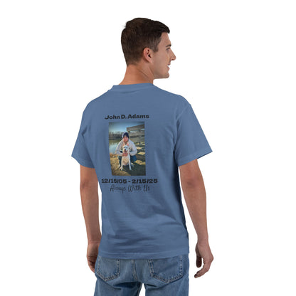 Man wearing a blue t-shirt with a photo and text on the back, standing against a white background
