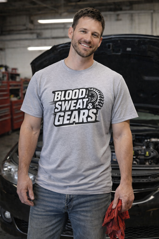 Man wearing a 'Blood, Sweat & Gears' t-shirt standing in front of a car with the hood open.