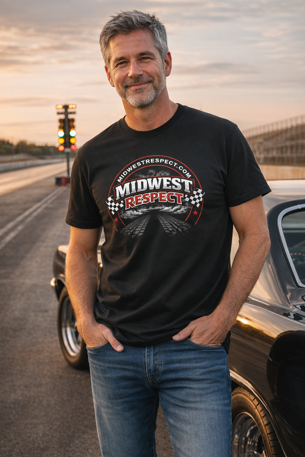 Man wearing a black t-shirt with 'Midwest Respect' logo standing on a road with a car in the background.