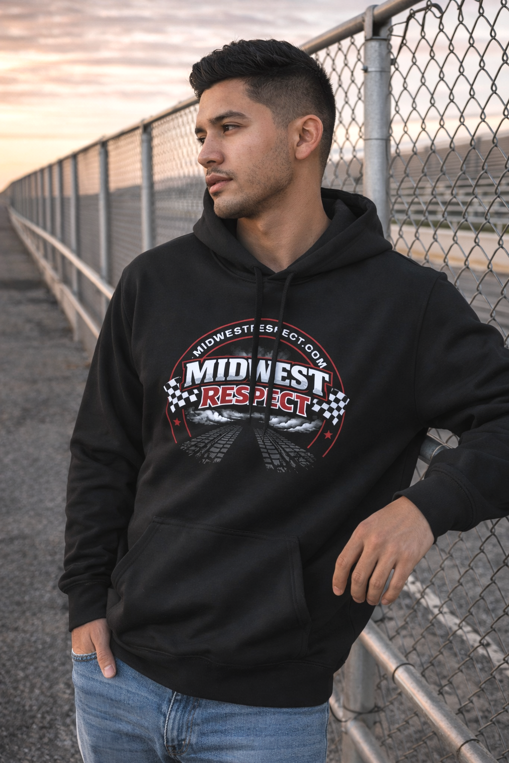 Man wearing a black hoodie with 'Midwest Respect' logo standing near a fence.