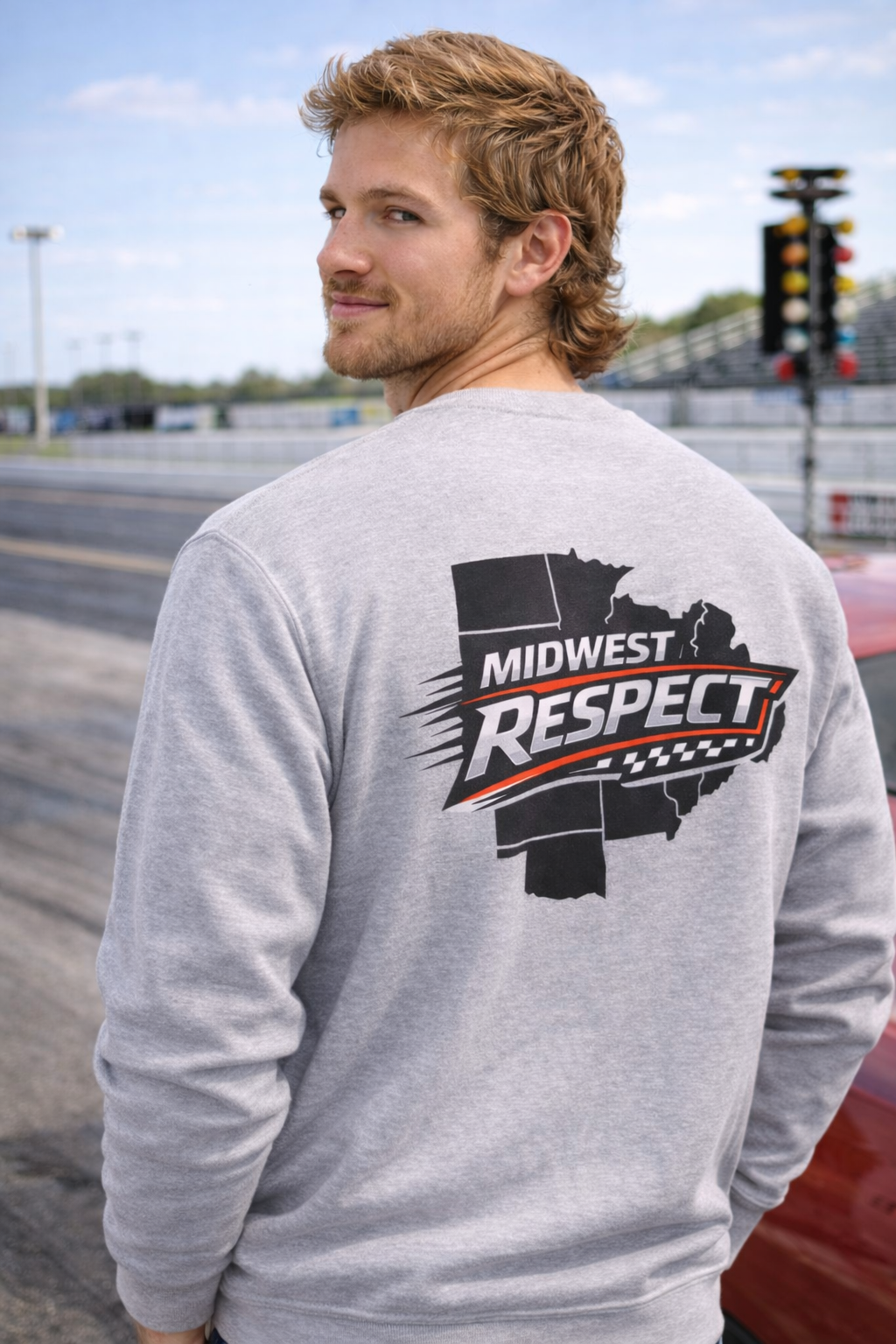 Person wearing a gray sweatshirt with 'Midwest Respect' graphic on a race track background