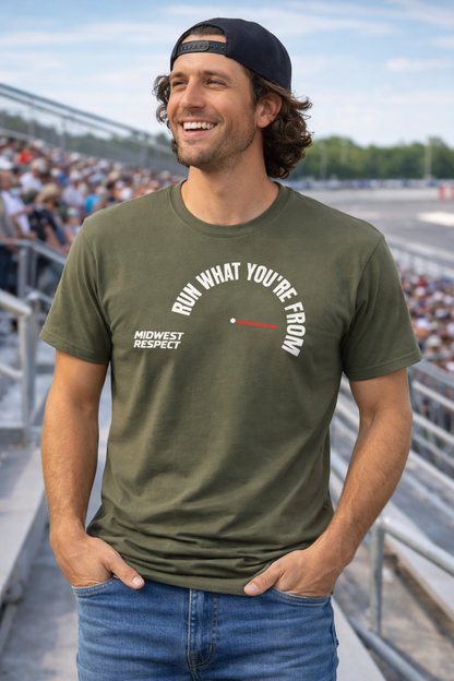 Man wearing a green t-shirt with text at a race track event